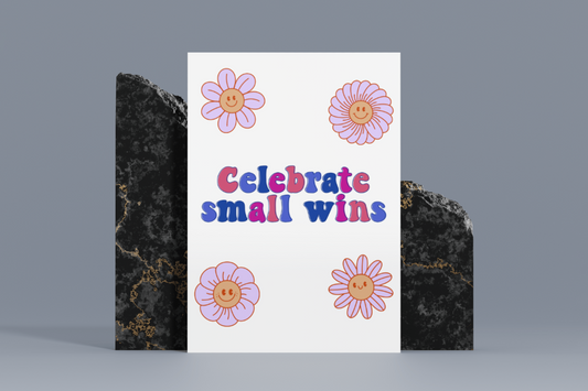 A colorful 8x10 metal sign featuring the text “Celebrate Small Wins” in bold letters, surrounded by four smiling flowers on a white background.